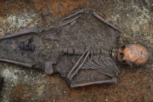 The skeleton and Christian cross as they were found in Trumpington Meadows, Cambs a site which has been confirmed as one of the UK's earliest Christian burial sites.
