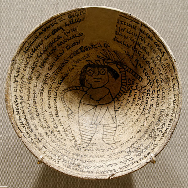 Incantation bowl with an Aramaic inscription around a demon. Now on display at the Metropolitan Museum of Art. Photo by Marie-Lan Nguyen (2011)
