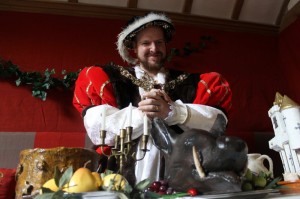 King Henry VIII (Nathan Wade) surveys the Tudor-feast inspired top table at Barley Hall, York. Photo courtesy  Jorvik Group