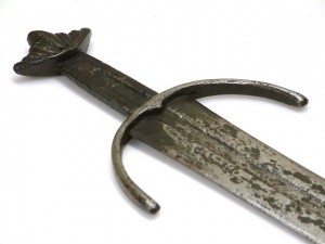 Cawood sword -Sword with curved medieval-style guard and lobed Viking-style pommel. Inscribed on both sides of the blade. Image courtesy of York Museums Trust