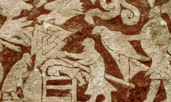 A section from the Stora Hammars I stone from Gotland, Sweden. The illustration shows a man lying on his belly with another man using a weapon on his back. There is a Valknut above him, and two eagles, one of which is held by a man to the right.