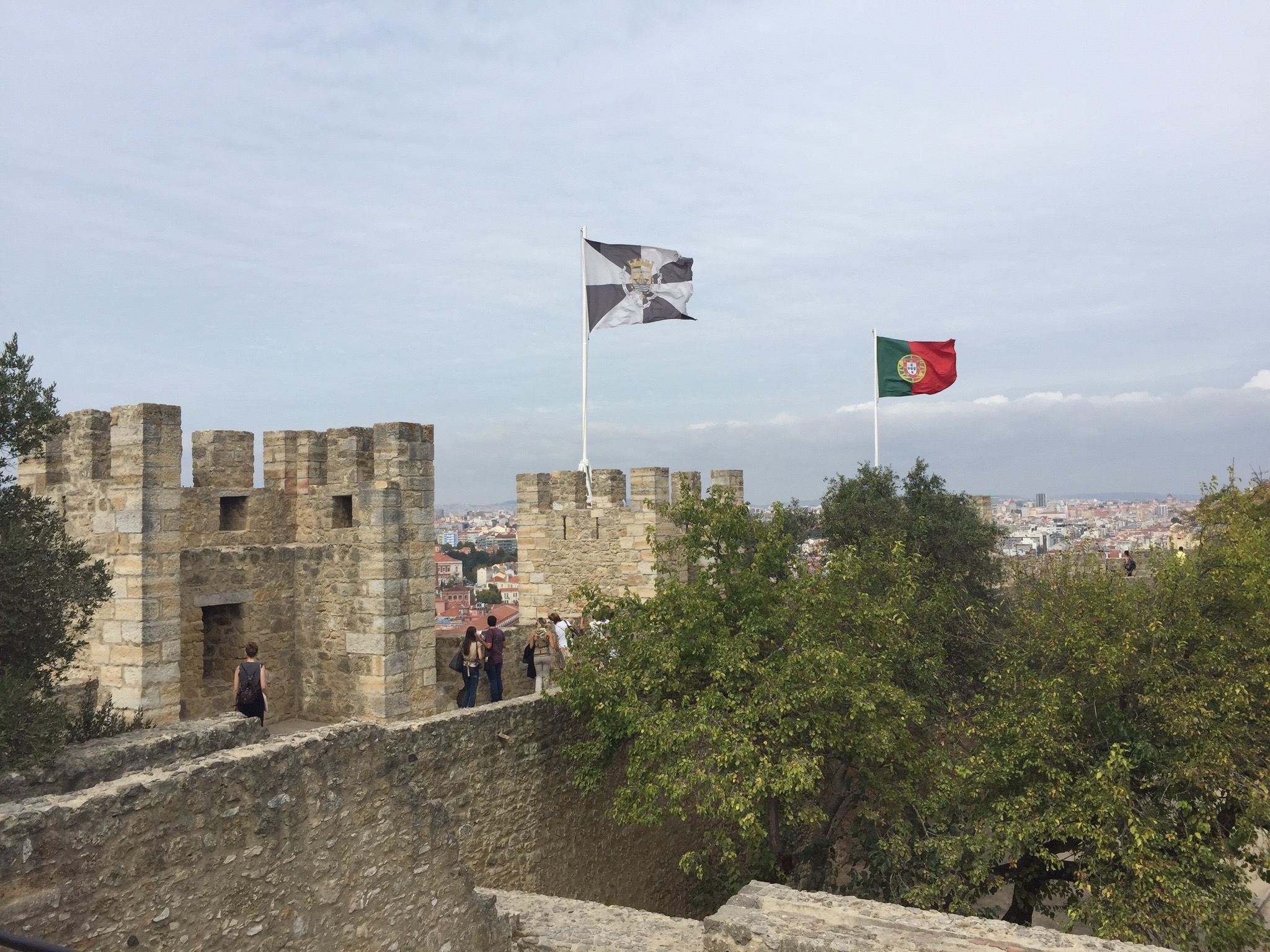 Walking along the castle walls, you can see the red and green flag of Portugal whipping in the wind alongside the black and white flag of the city. Photo by Medievalists.net.